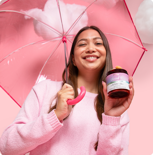 Smiling woman holding a jar labeled 'vena cloud 9' and a pink umbrella