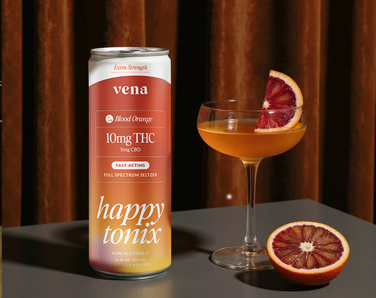 Vena blood-orange seltzer can labeled 10mg THC and 5mg CBD next to a cocktail and sliced blood orange