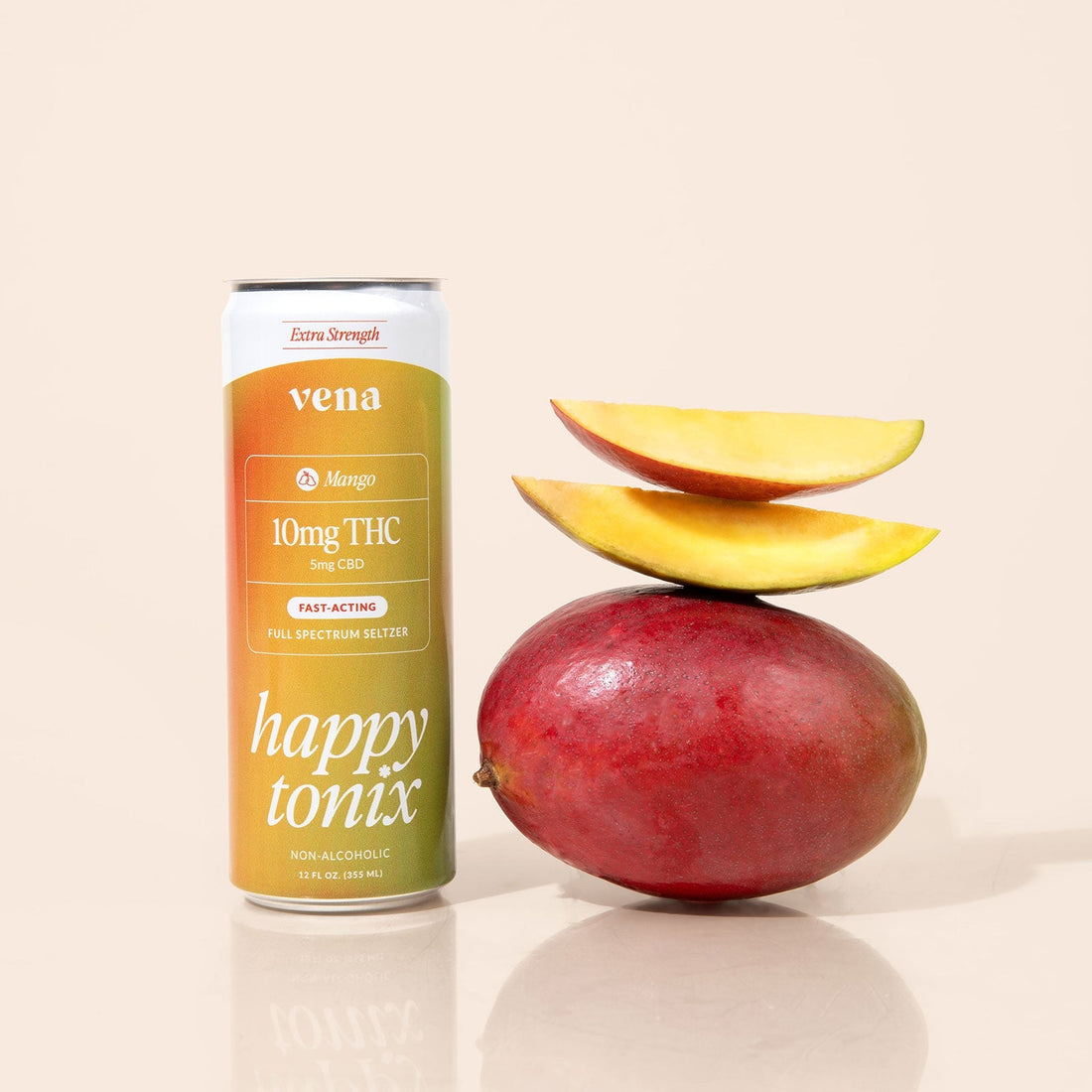 Vena mango Happy Tonix can (10mg THC, 5mg CBD) beside whole mango topped with two mango slices
