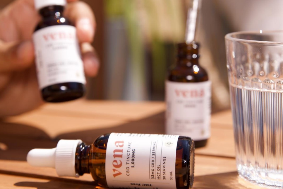 vena CBD TINCTURE 1,000MG 33MG CBD / 1 SERVING MCT OIL 30 SERVINGS 30 mL, amber tincture bottles and a glass