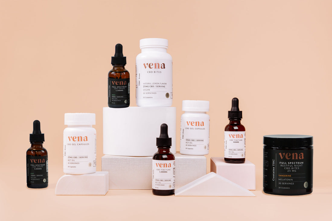 Vena CBD product display: assorted tincture bottles, gel capsule bottles, and gummy jar on peach backdrop.